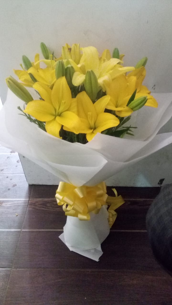 Yellow Asiatic Lilliums in White Paper delivery in Ahmedabad