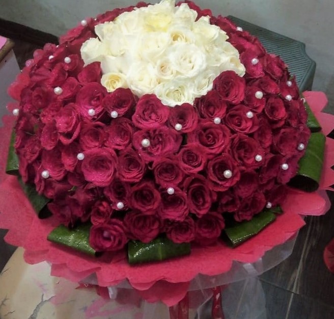 Flowers Delivery in FaridabadRed & White Rose in Paper Wrapping